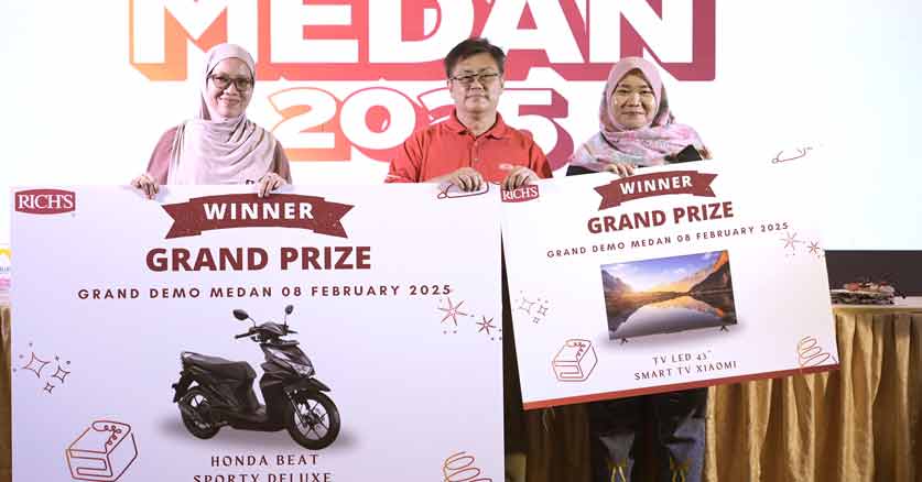 Pemenang grand prize Grand Demo Rich's memegang papan hadiah utama sepeda motor dan TV LED